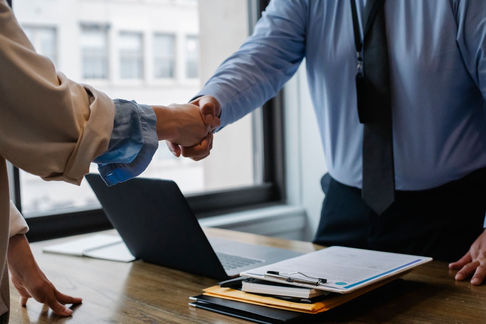 Attorneys shaking hands over a referral